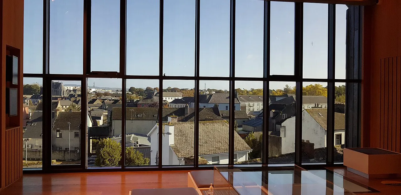 Kilkenny rooftops viewed through a window of the Medieval Mile Museum.